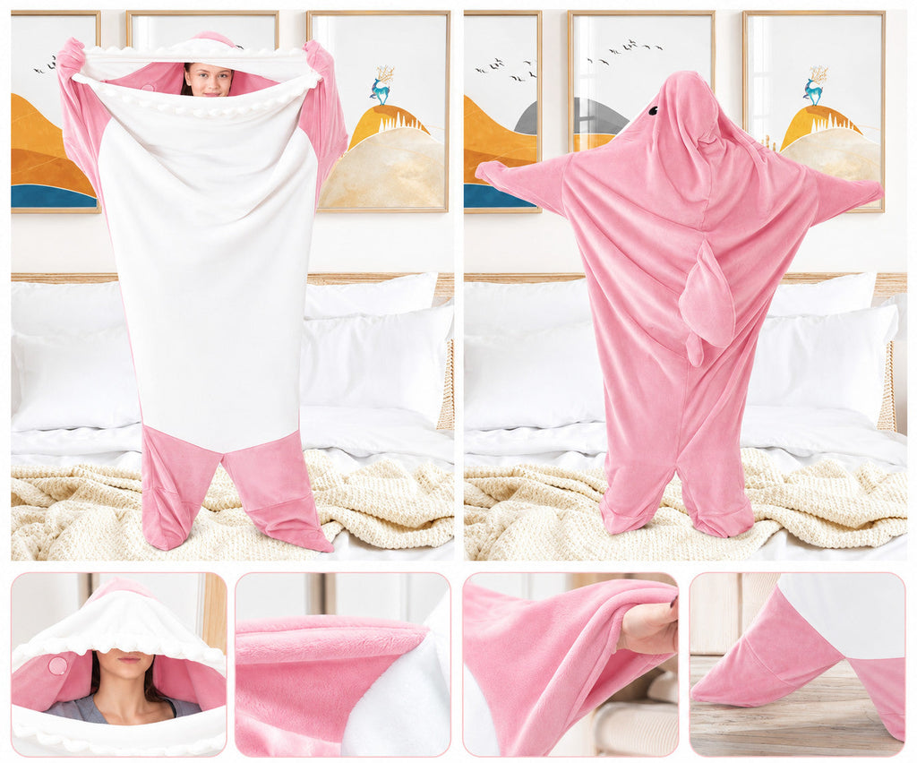 Sharkkuddle onesie hood and fabric detail on a bed